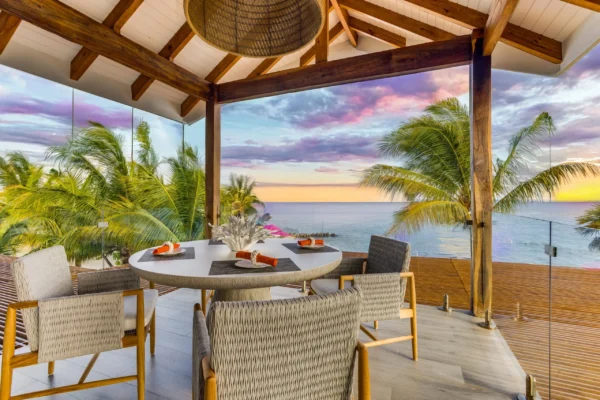 MAGENTA_Caye_Luxury_Private_Island_rooftop_dining_sunset_sm-scaled
